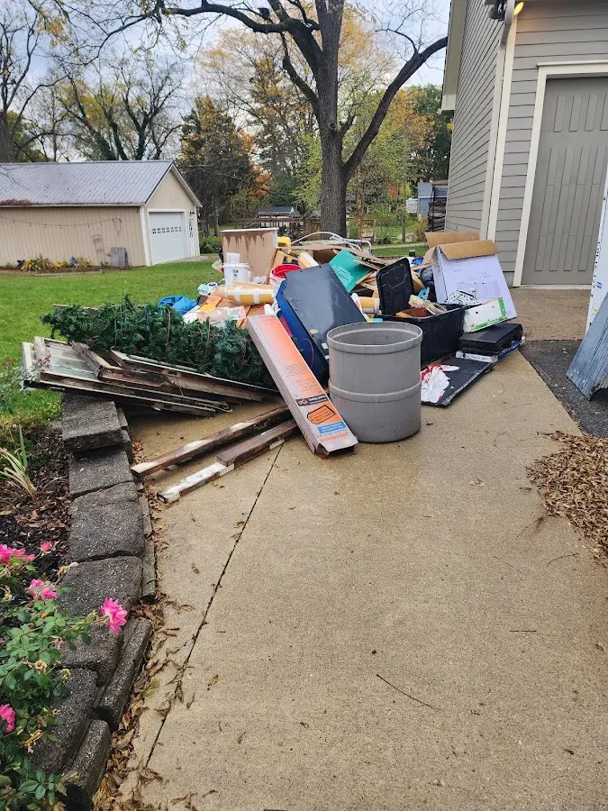 Dumpster being loaded with debris for 3 Yard Dumpster Rental in Burien